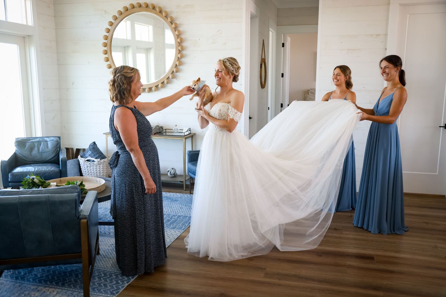 Final wedding dress preparations in bright sunlit room with elegant decor.