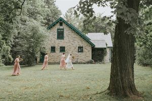 Bride and bridesmaids walking towards the building
