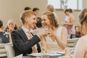 Groom and Bride cheers at reception