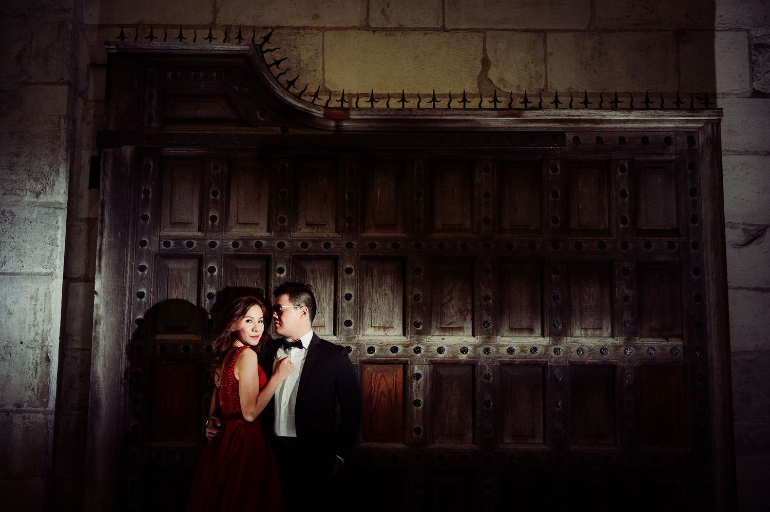 Dramatically lit night-time photograph in London of couple in evening dress