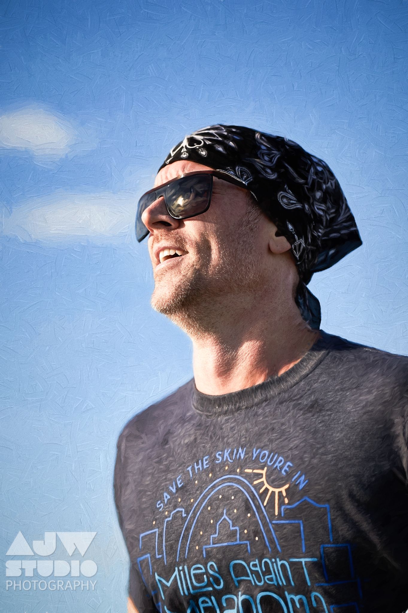 Low angle shot of a participant wearing bandana and sunglasses at an outdoor event.