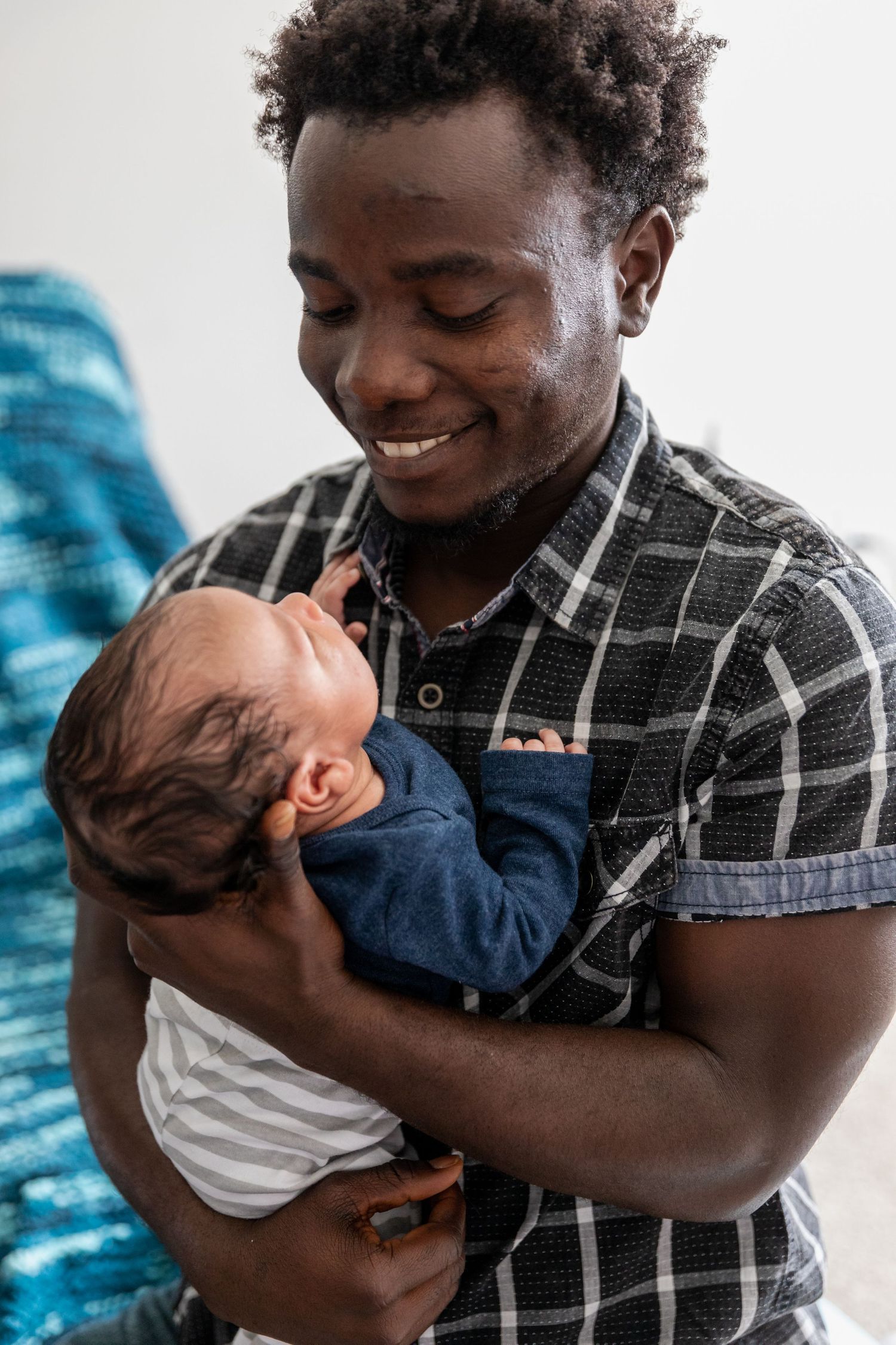 Intimate portraits showing tender moments between parent and baby against white background.