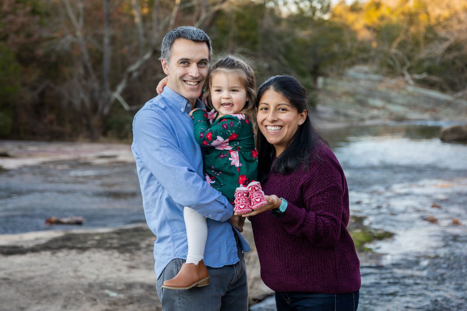 Family portrait series taken outdoors showing playful interactions near a waterfront.