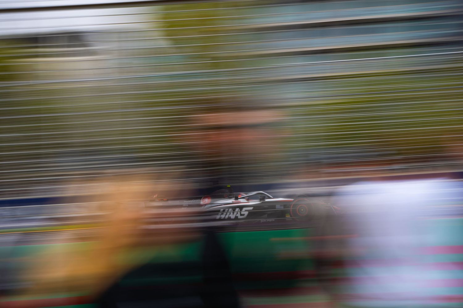 Blurred motion shot of a race car speeding past during a motorsport competition.