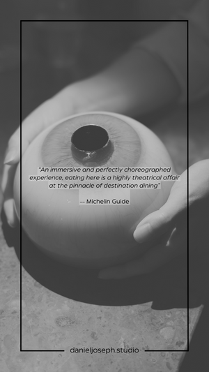A black dish with Michelin Guide quote overlay in dramatic lighting.