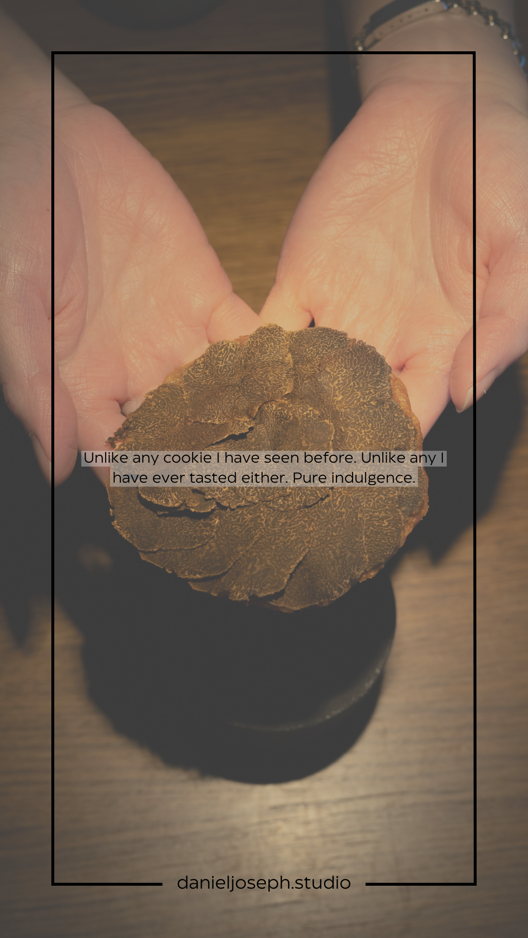 A large dark truffle being displayed in open palms with text overlay.