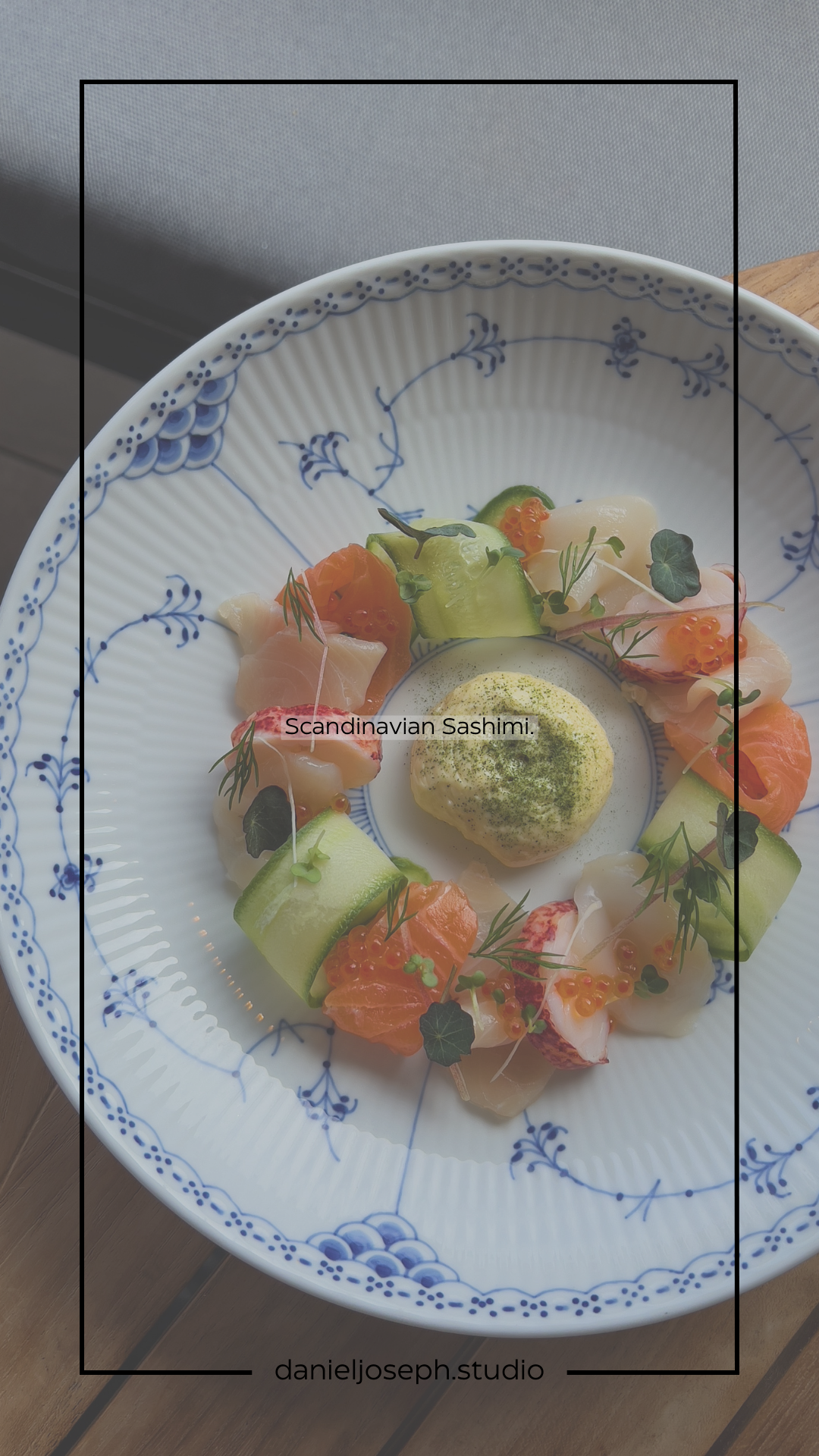 Scandinavian-style sashimi arranged in a circle on a blue and white patterned plate.