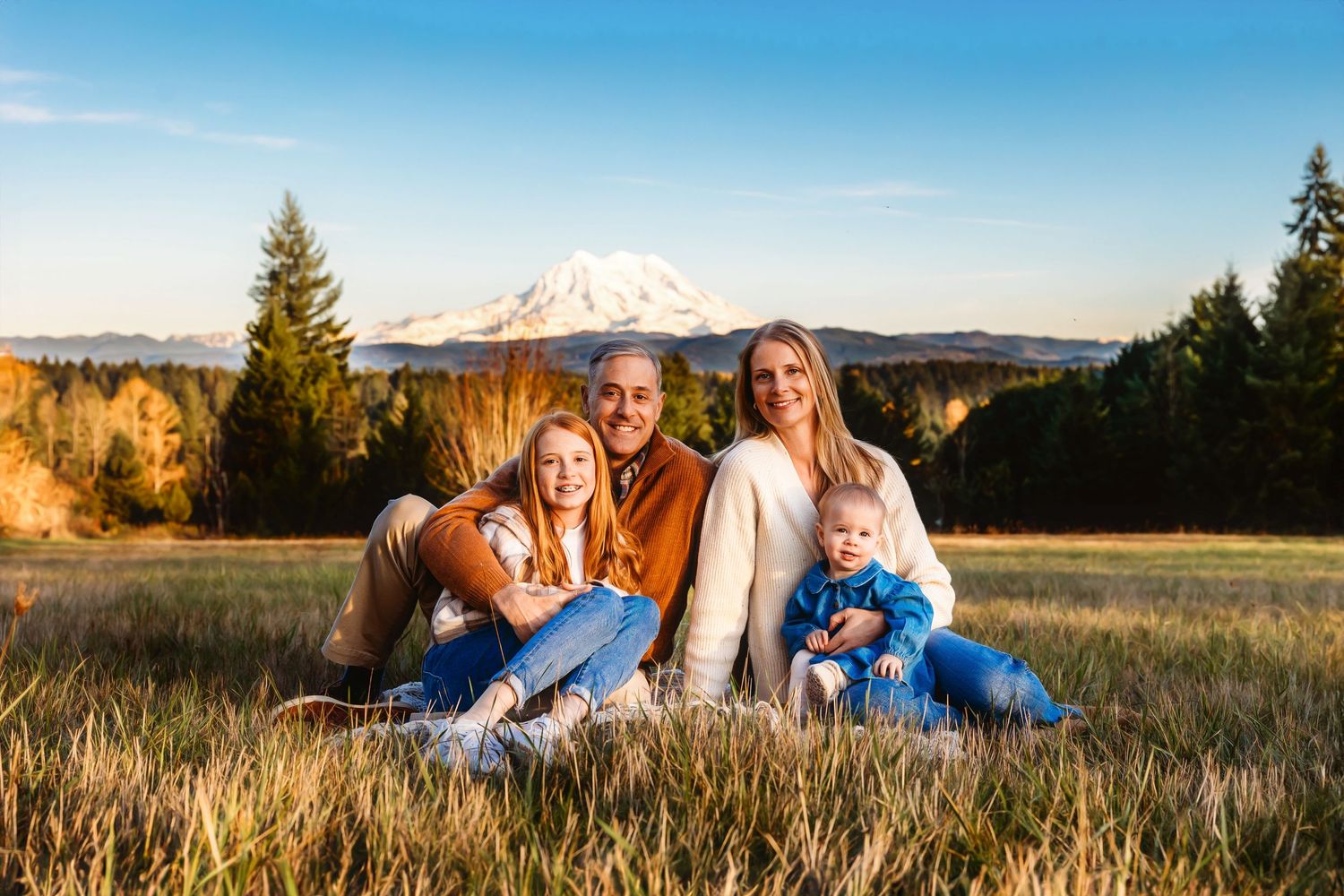 Family photo session in big field with view of Mt. Rainier