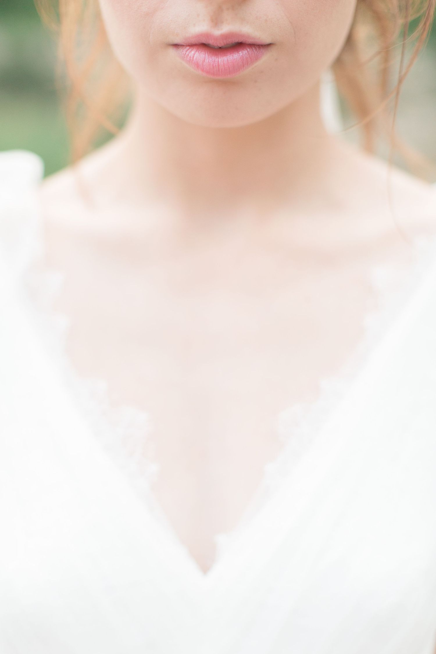 Close-up portrait showing soft pink lips and delicate neckline in a white dress with dreamy, ethereal lighting euridge manor