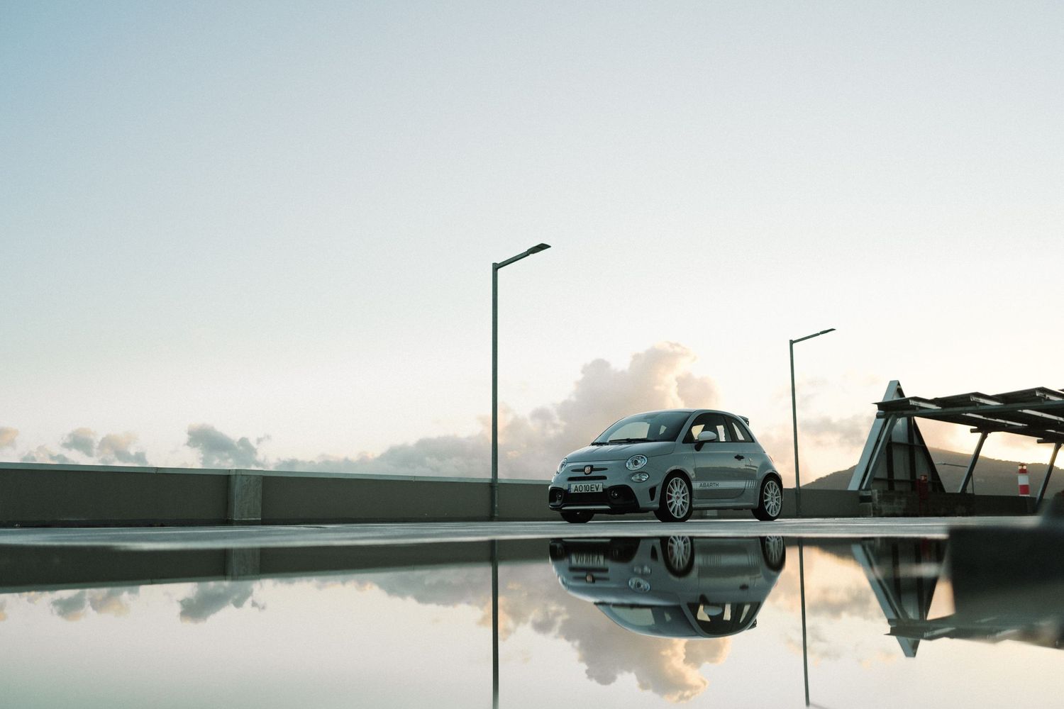 Minimalist landscape photos with reflective surfaces and street lamps at dusk.