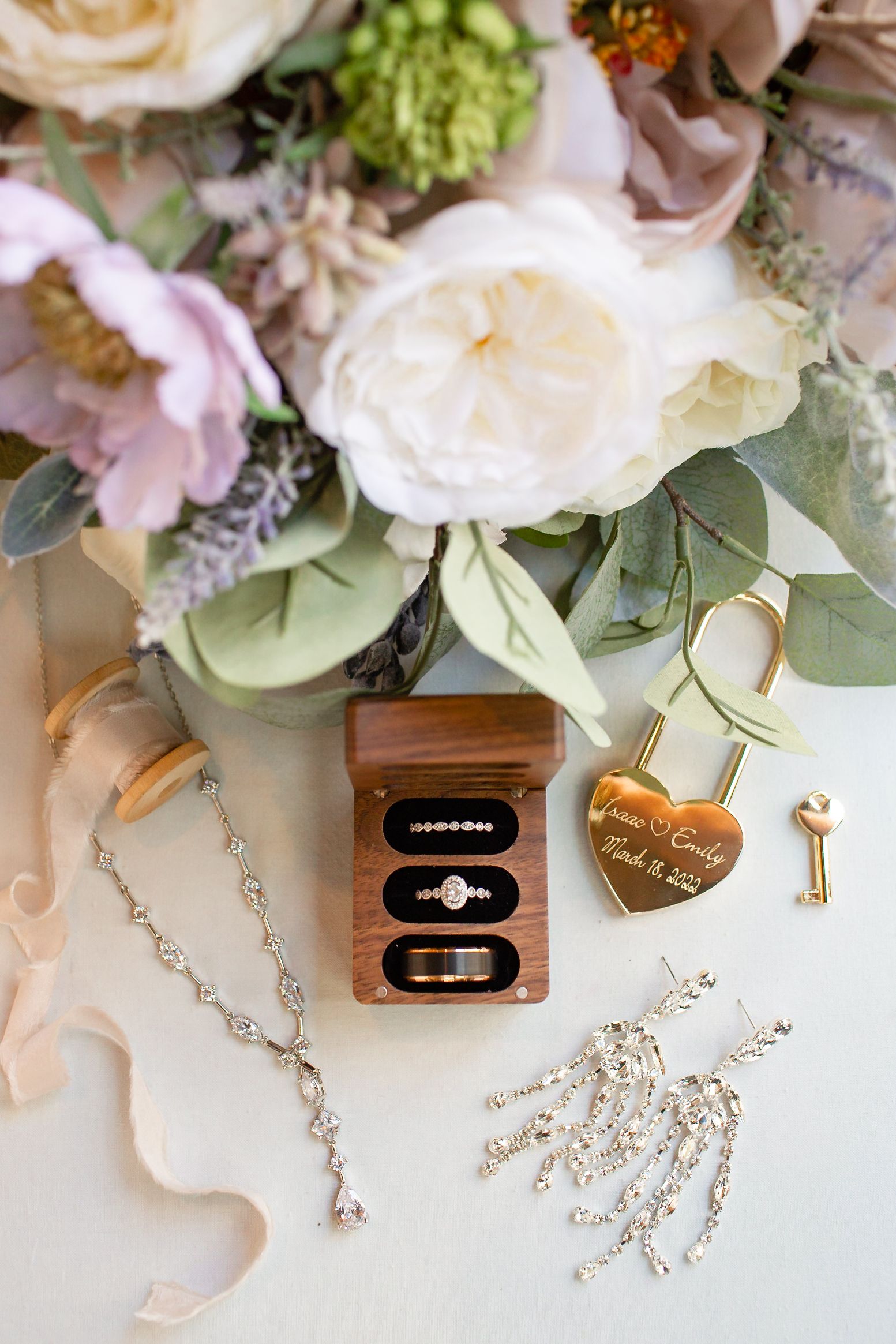 Wedding details flatley including the bride and groom's rings, jewelry and bouquet.