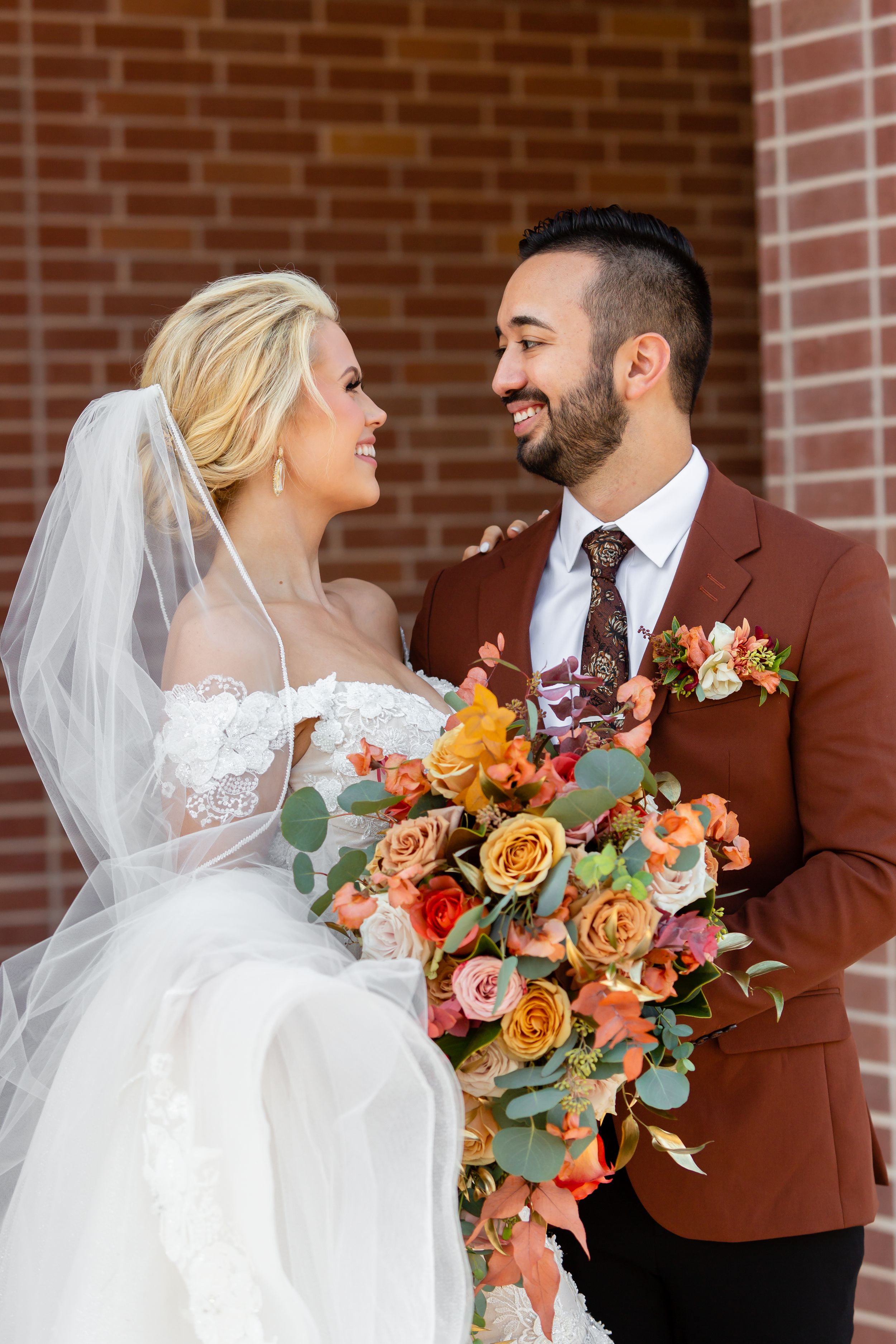 Newly married couple looks lovingly at each other after their wedding in Houston, TX.