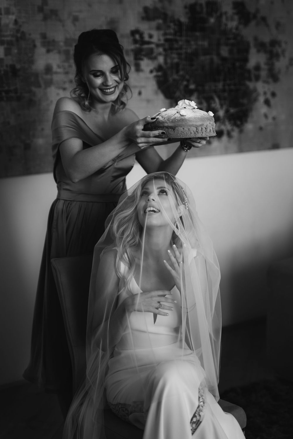 Playful black and white moment between bridesmaids during wedding day preparations.