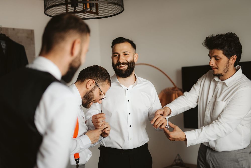 Groomsmen sharing a lighthearted moment during wedding preparations.