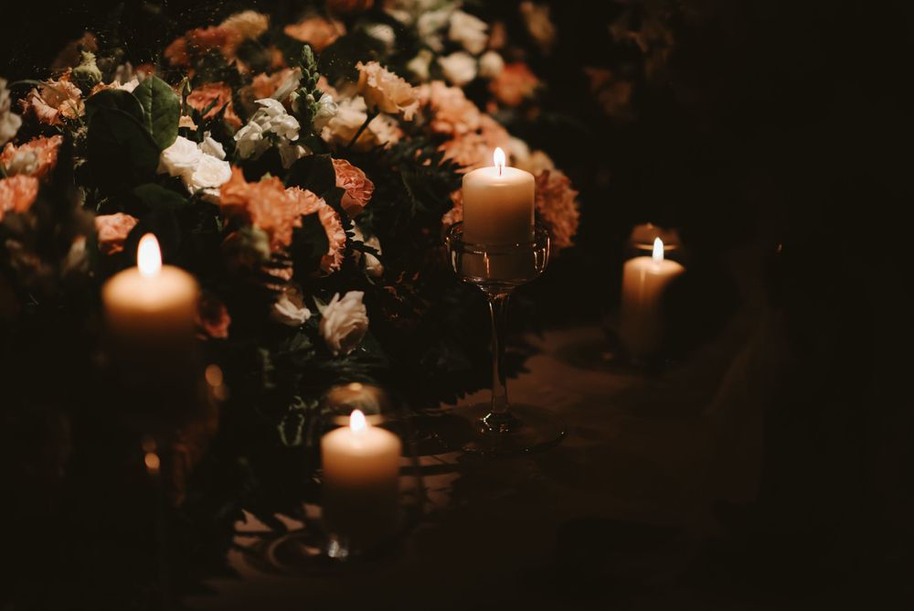 Romantic candlelit table decoration with soft-focus flowers creating an intimate atmosphere.