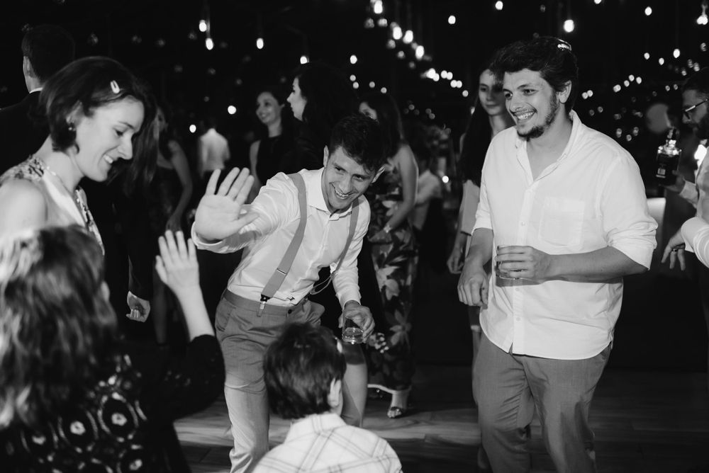 Party guests dancing and having fun at a nighttime celebration.