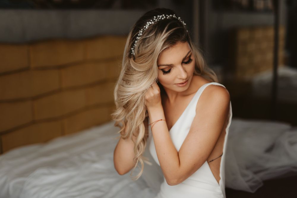 Intimate bridal portrait showing elegant white dress and romantic styling.