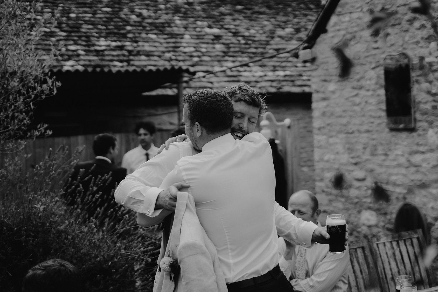 groom hugging groomsmen before his wedding ceremony in Oxfordshire