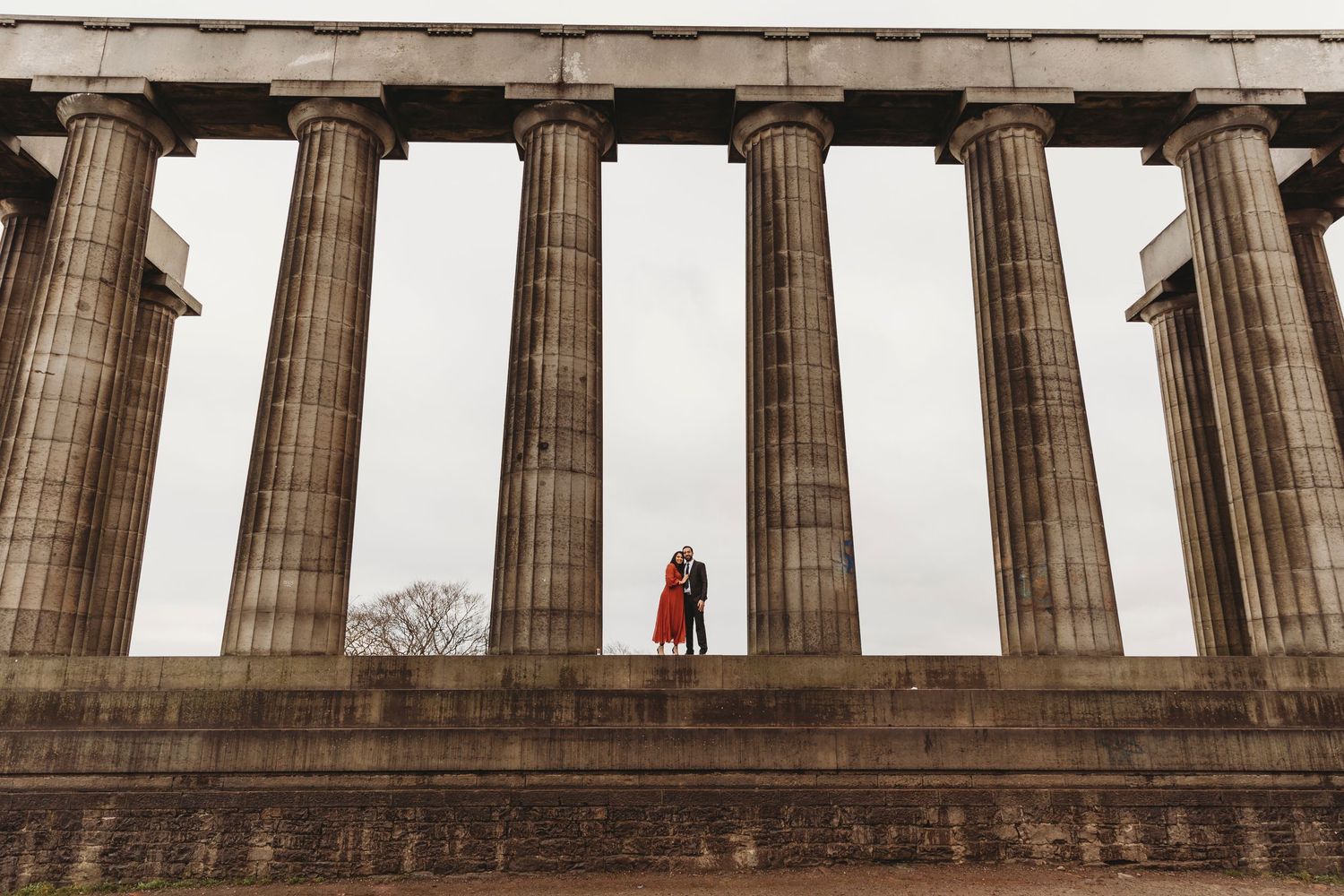 Dramatic silhouette against ancient Greek columns at the National Monument in Edinburgh.