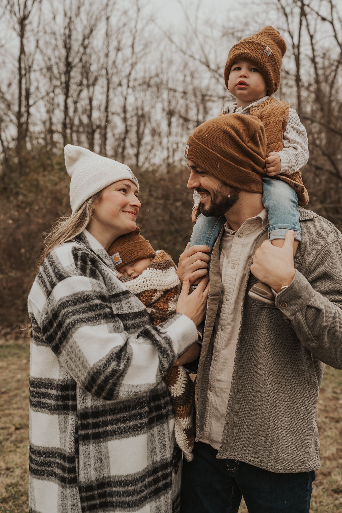 Playful family interaction captured in warm earth tones during autumn photoshoot.