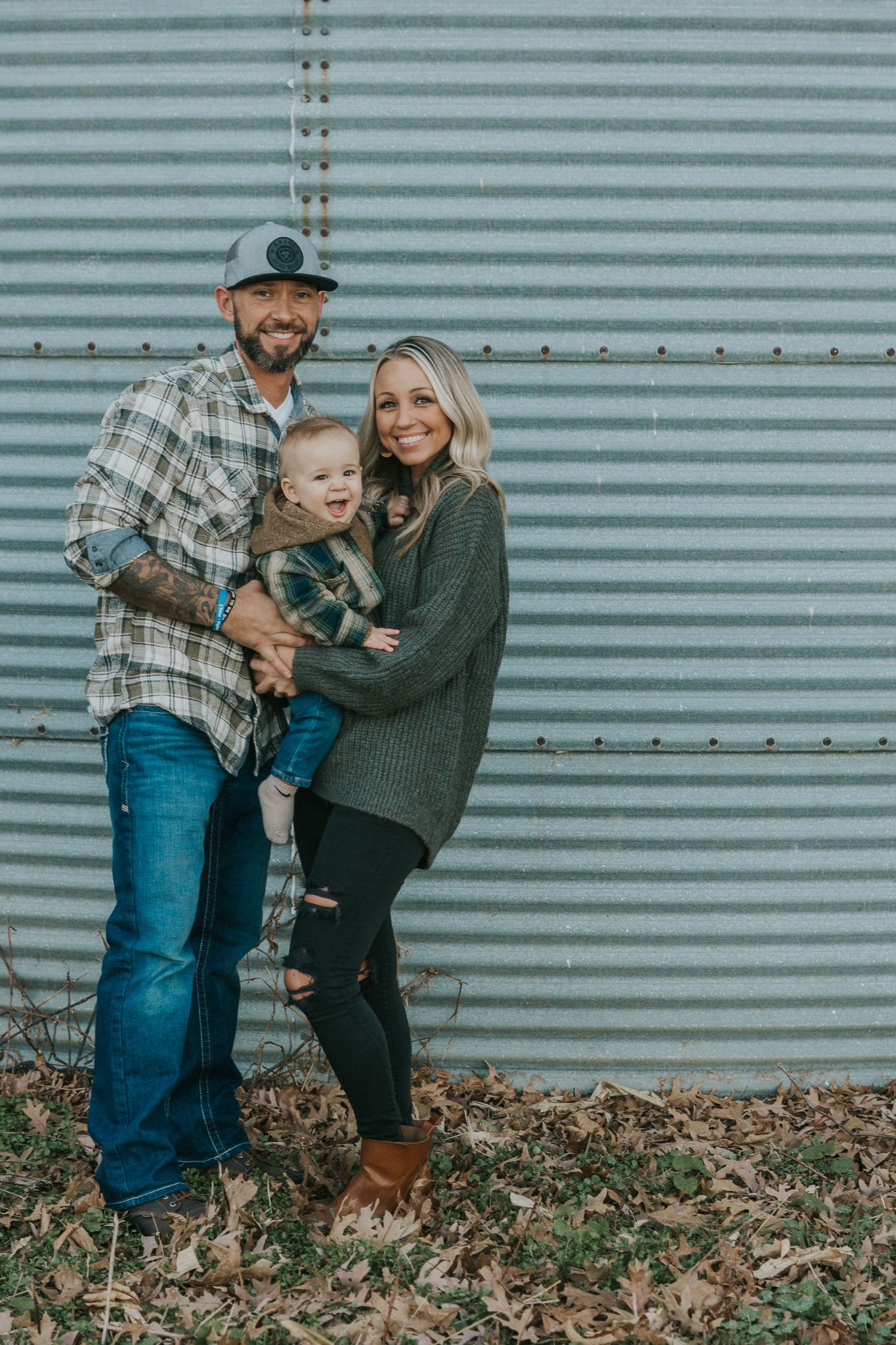 Candid family moments captured against an industrial metal wall background.