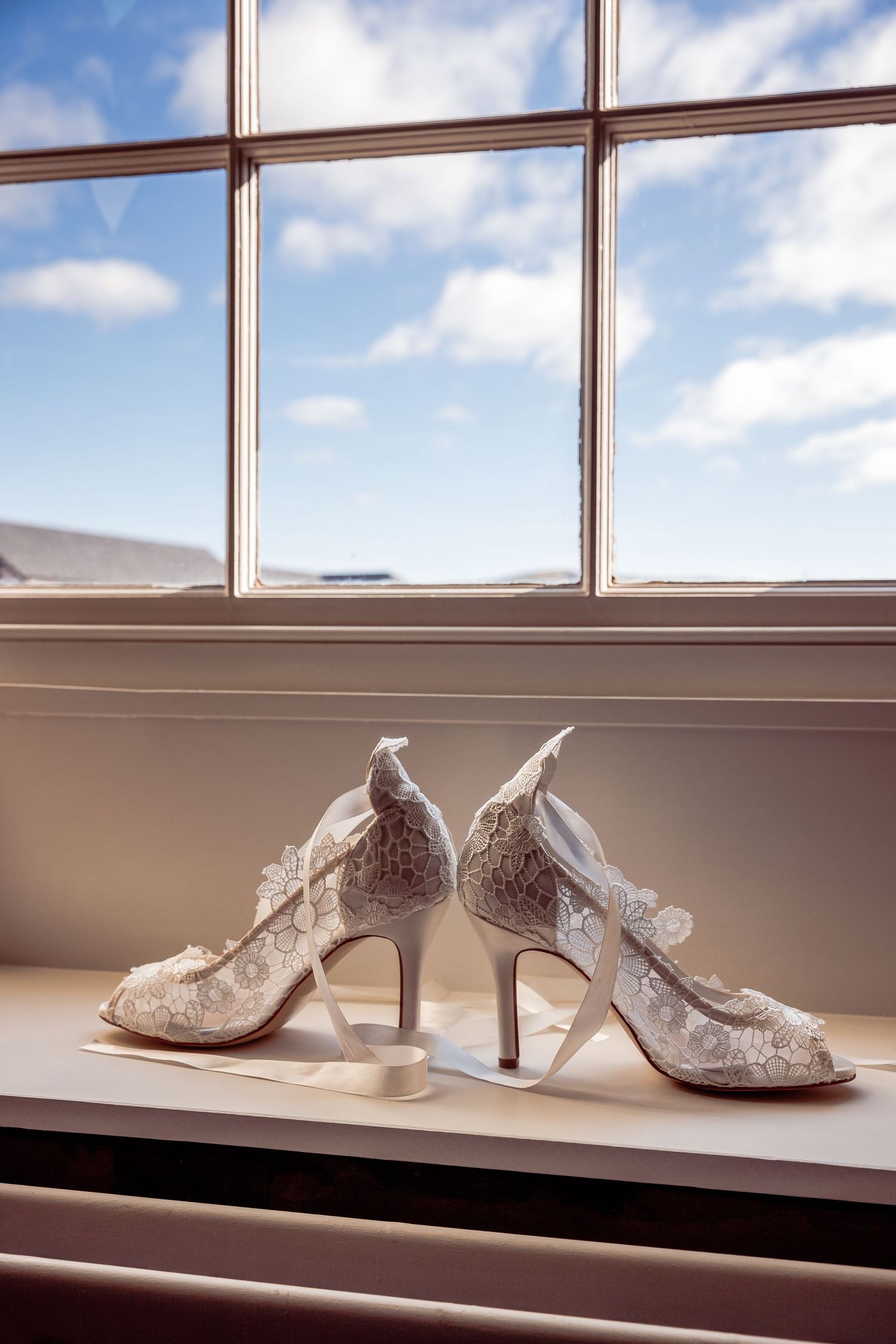 Brides Shoes on a Window Sill with Blue Sky