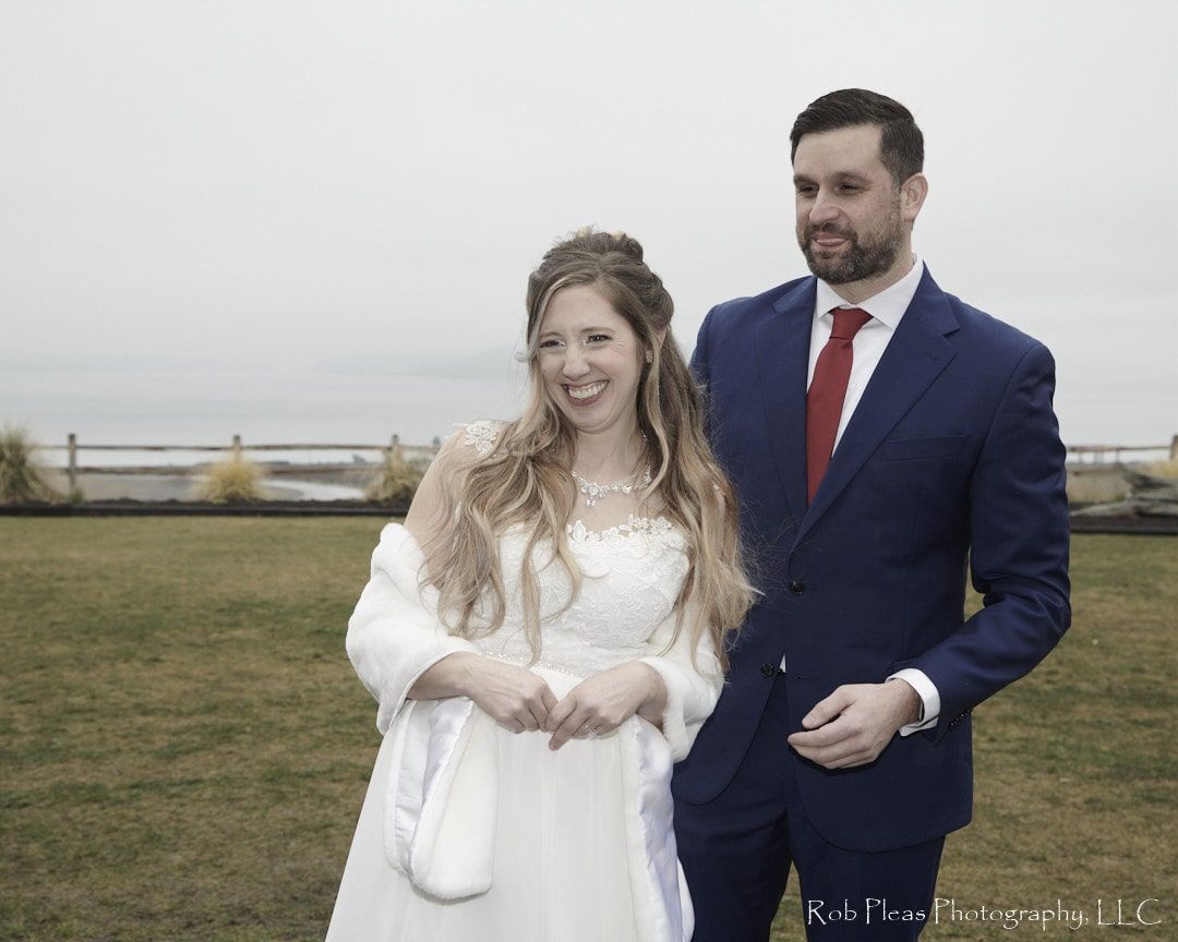 Bride and Groom formal laughing, groom sticking out tongue at Tacoma Environmental Services Building