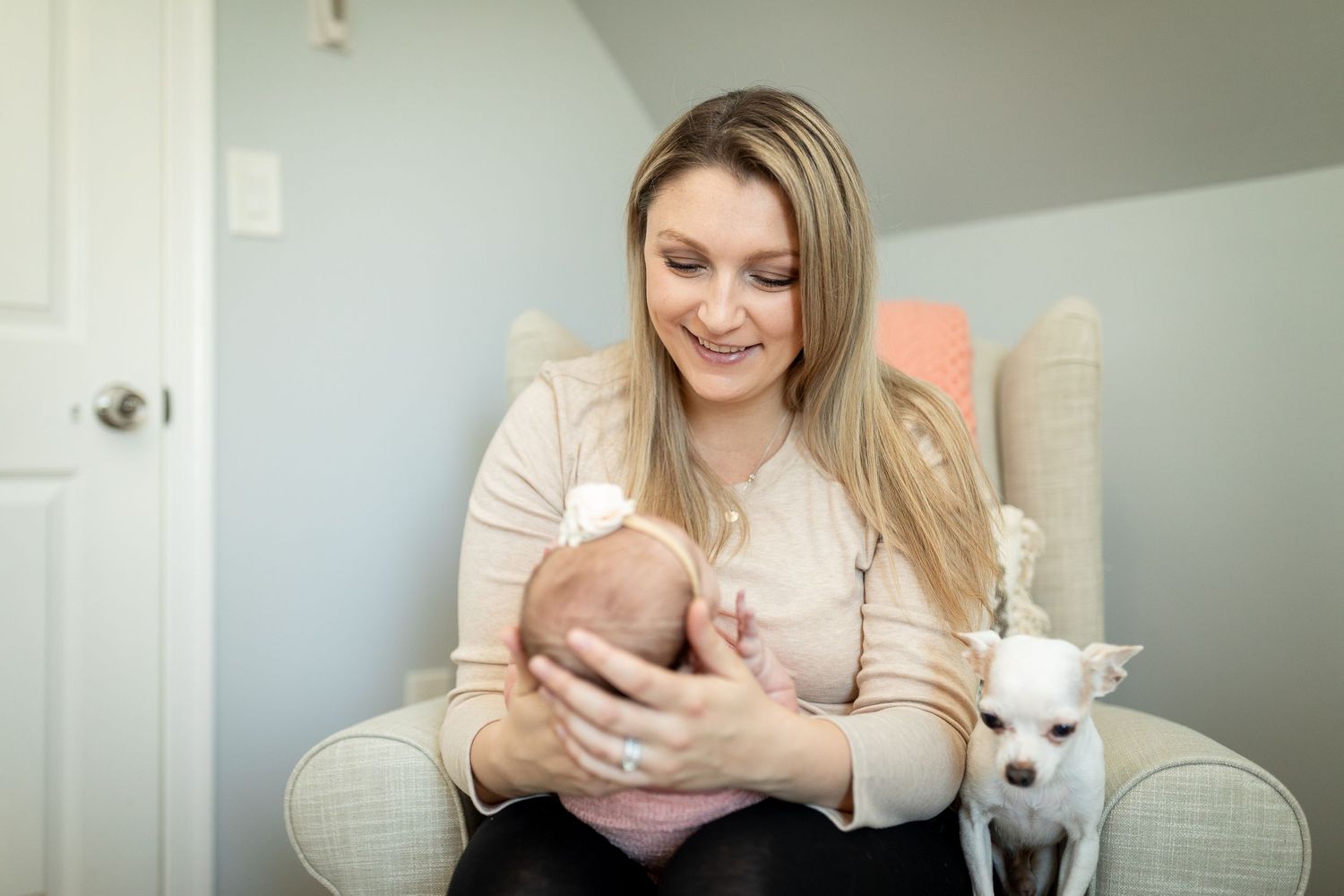 Tender moment between parent and infant in a peaceful nursery setting with natural lighting.