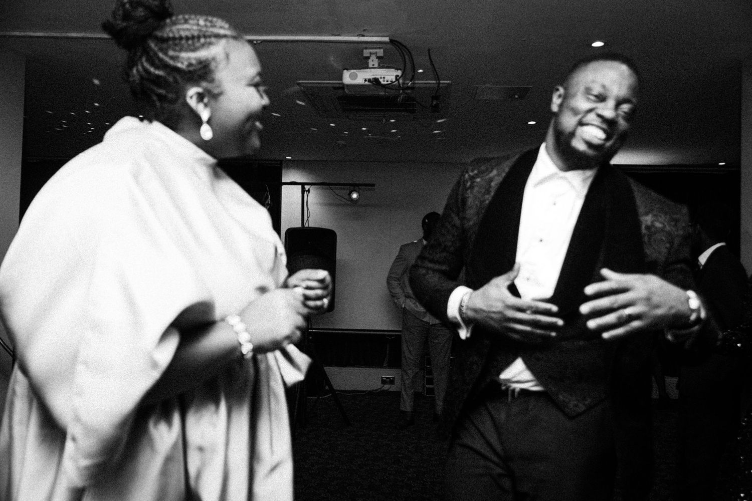 Two people having an animated conversation in black and white photography.