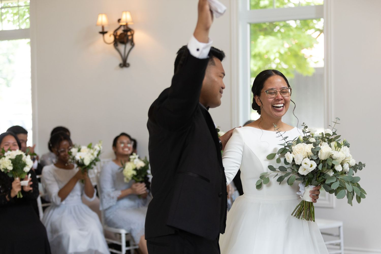 Natural light bright chapel wedding bride and groom exit natural green and white flowers