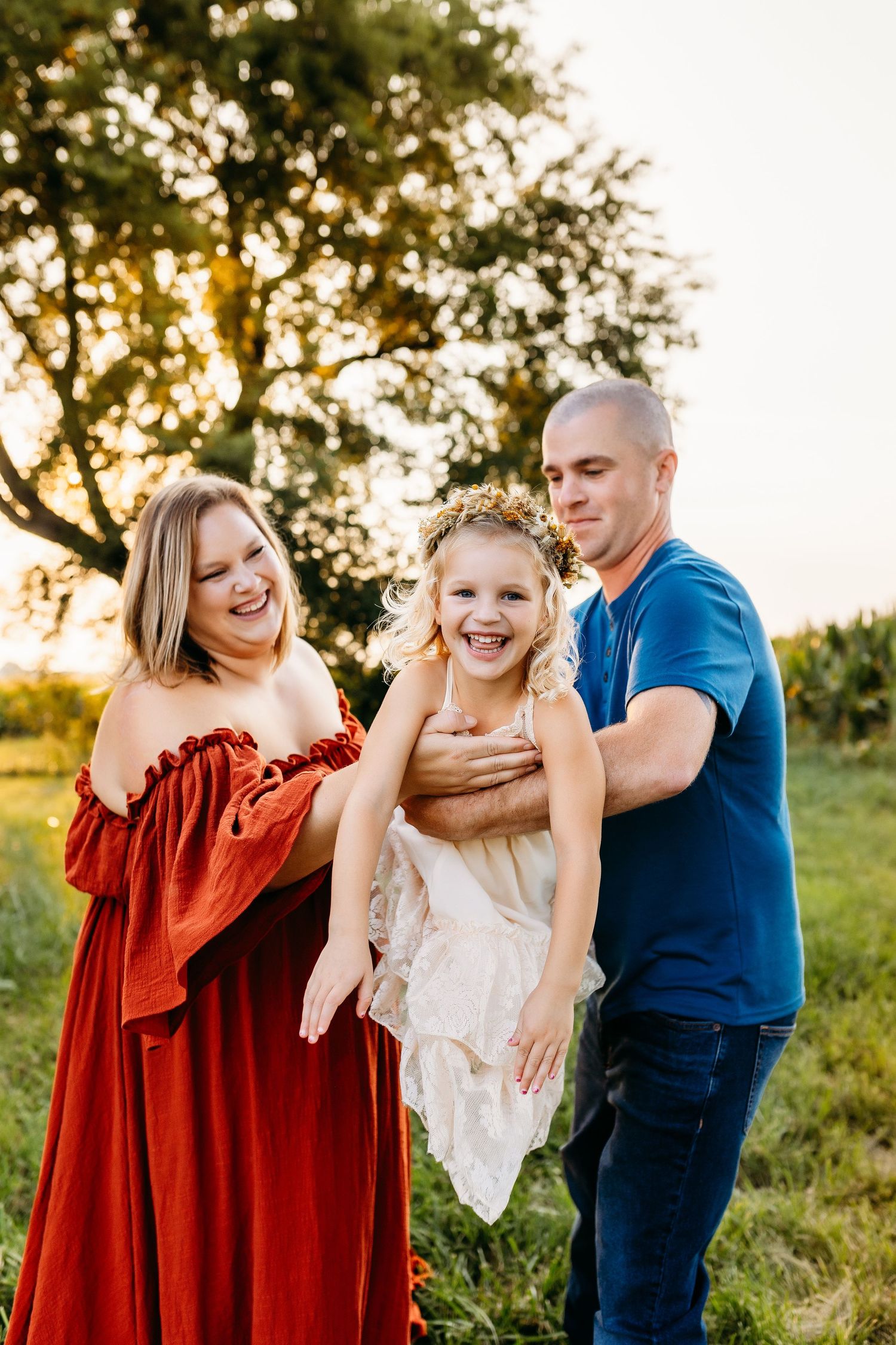A joyful family moment captured outdoors during golden hour.