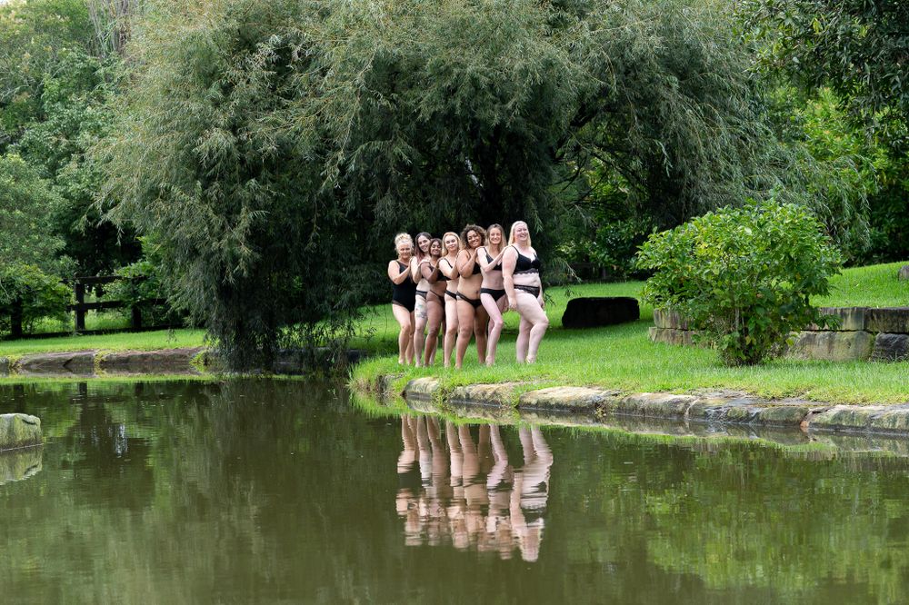 Women posing by water in lingerie