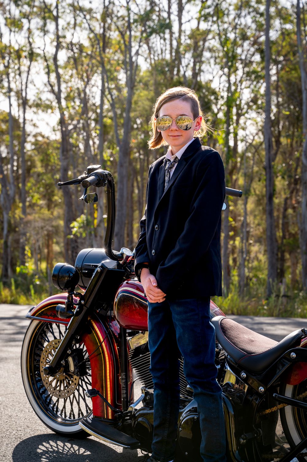 Boy posing by his motorbike ride for year 6 formal