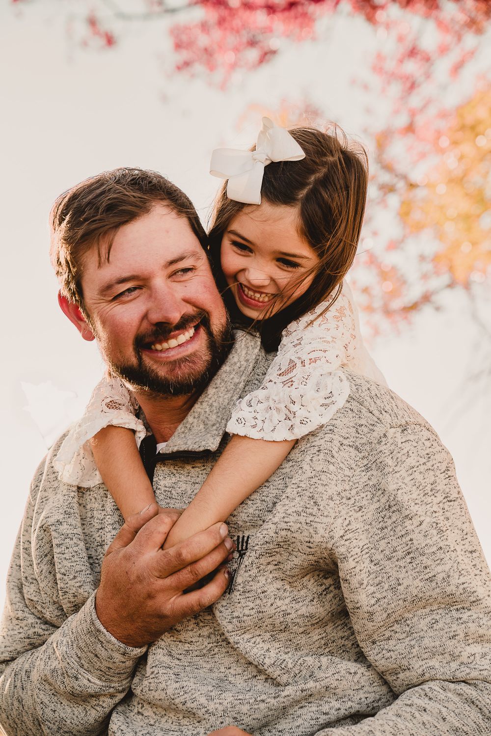 A heartwarming autumn photoshoot with warm tones and natural expressions.