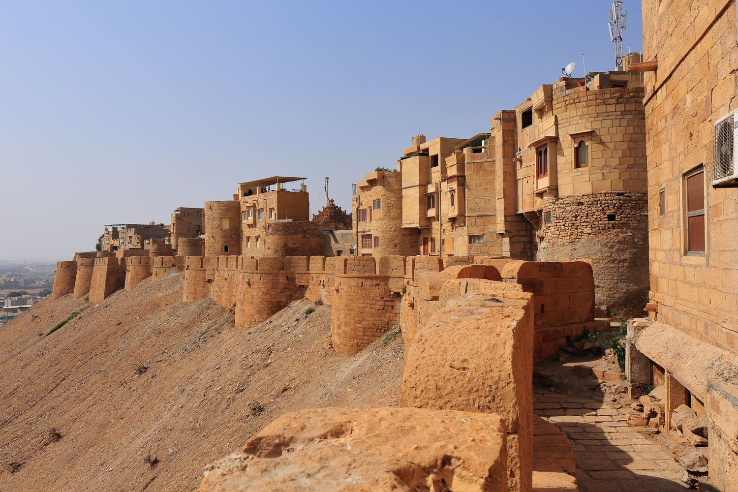 Ancient fortress walls and towers stretching along desert ridge in Jaisalmer, India.