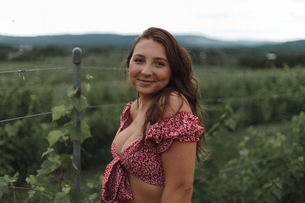 Lifestyle winery photo portrait of girl in dress in a field