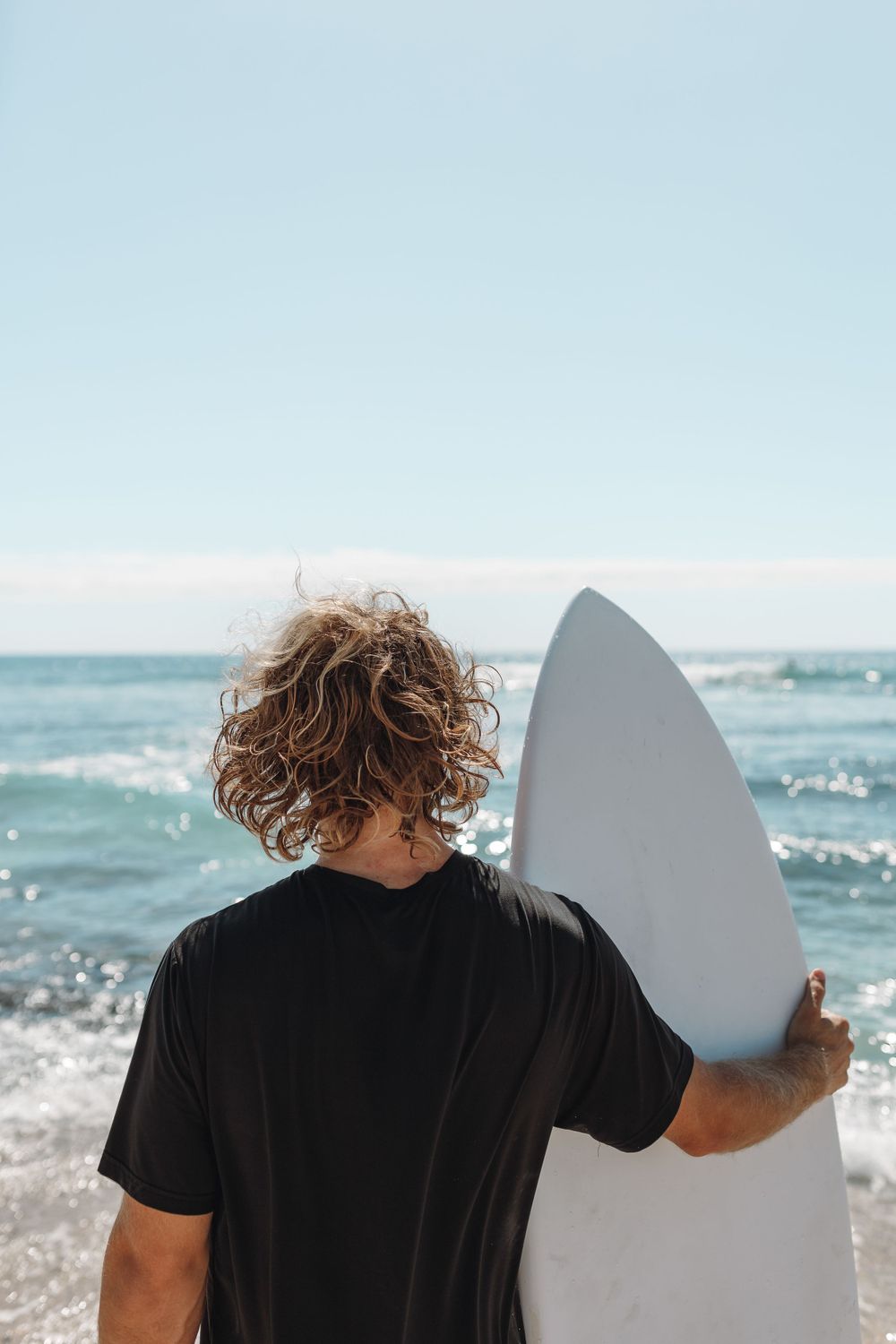 Hawaii surfer with surfboard by the ocean
