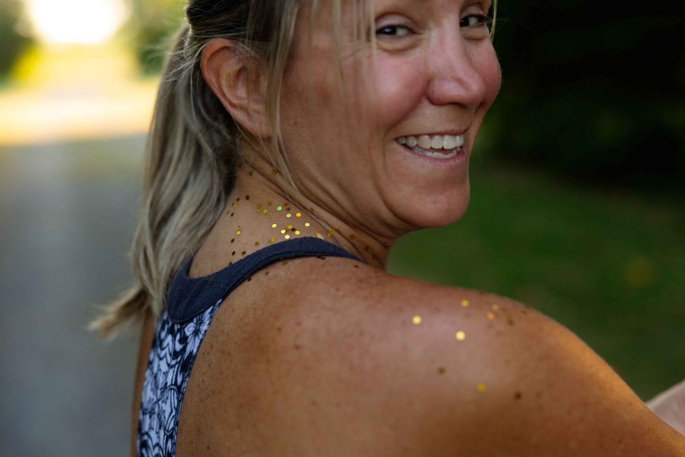 Athletic person with glowing skin enjoying golden hour sunlight outdoors on a summer evening.
