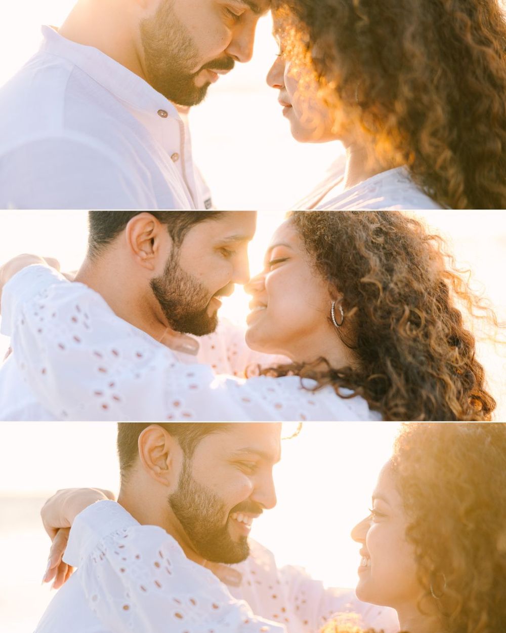 Romantic couple sharing intimate moments on a beach at sunset in white outfits.