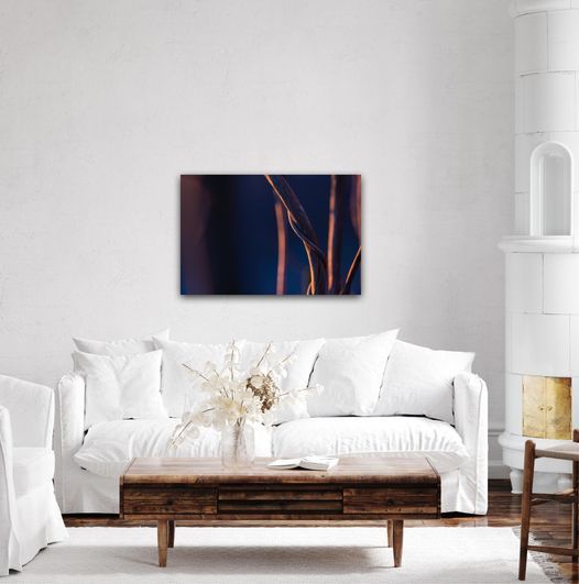 Minimalist white living room with modern furniture and abstract wall art.