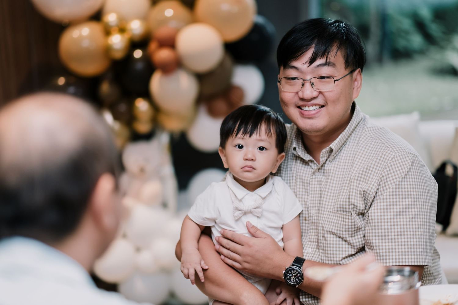 A celebratory gathering with balloon decorations and family moments.