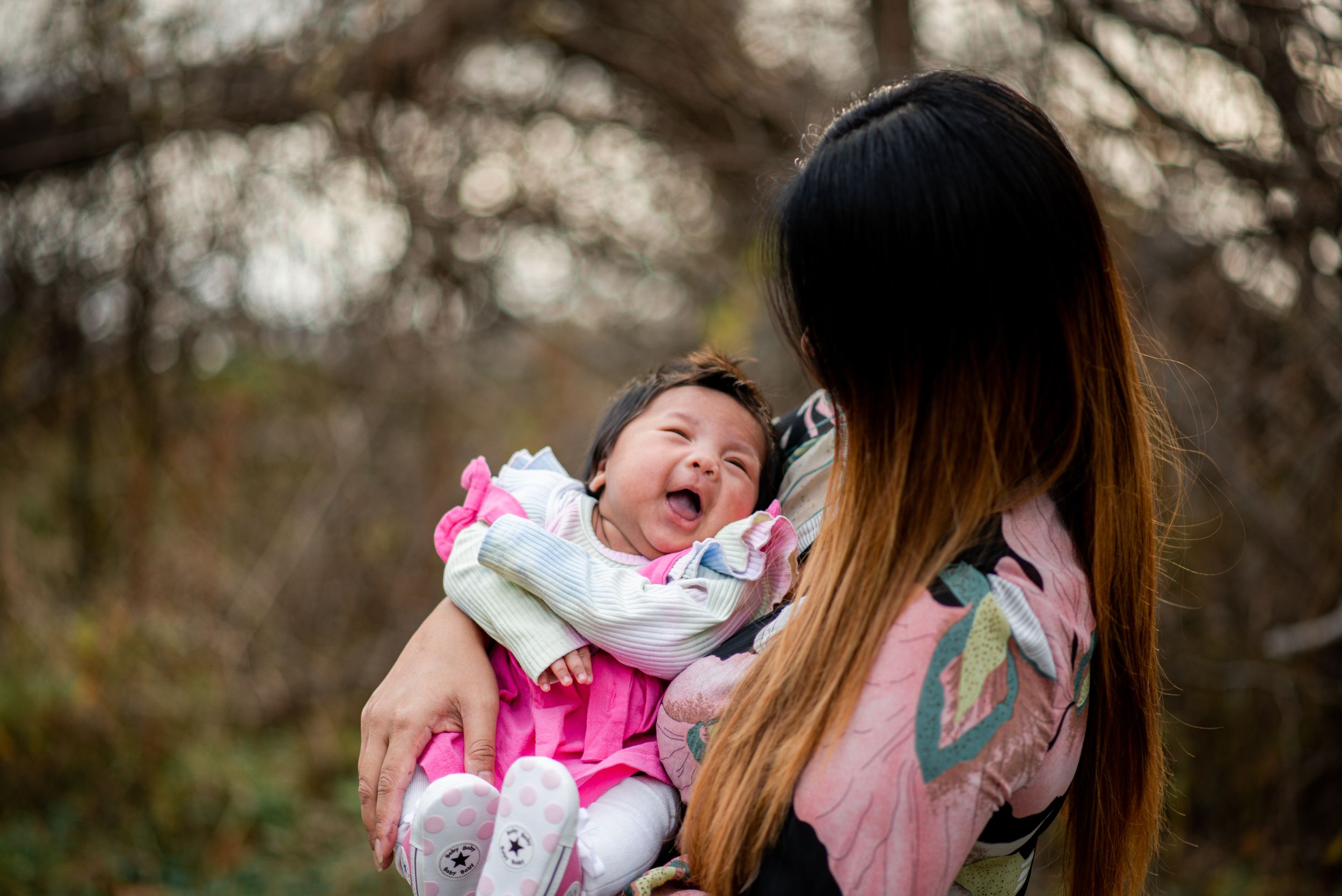 Sweet candid moments shared between parent and child in natural outdoor setting.