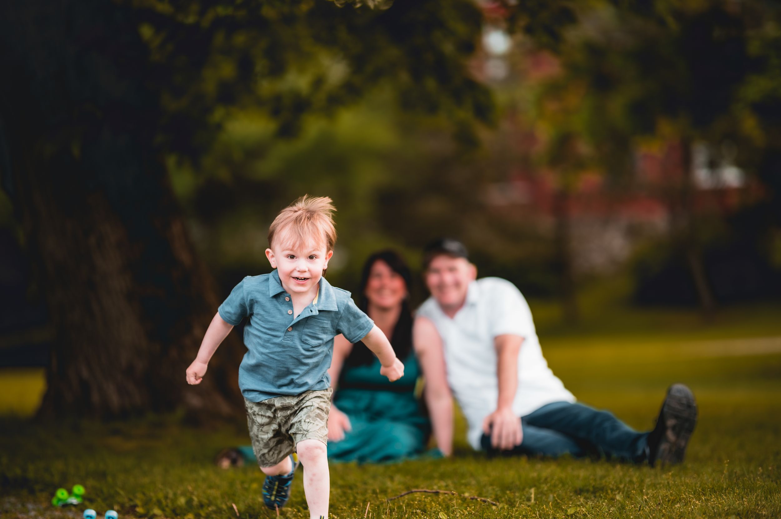 Candid family moments captured during outdoor photo session in park.