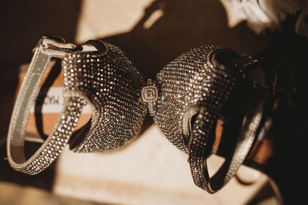 Close-up of crystal-encrusted wedding accessories in sepia tones.