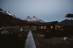Sunrise over a campsite in Torres del Paine National Park, Patagonia, capturing majestic mountains, serene landscapes, and adventurous natur