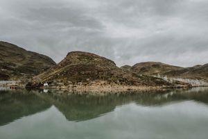 Stunning landscape of Patagonia captured from the water, showcasing mountains, pristine nature, and serene reflections.