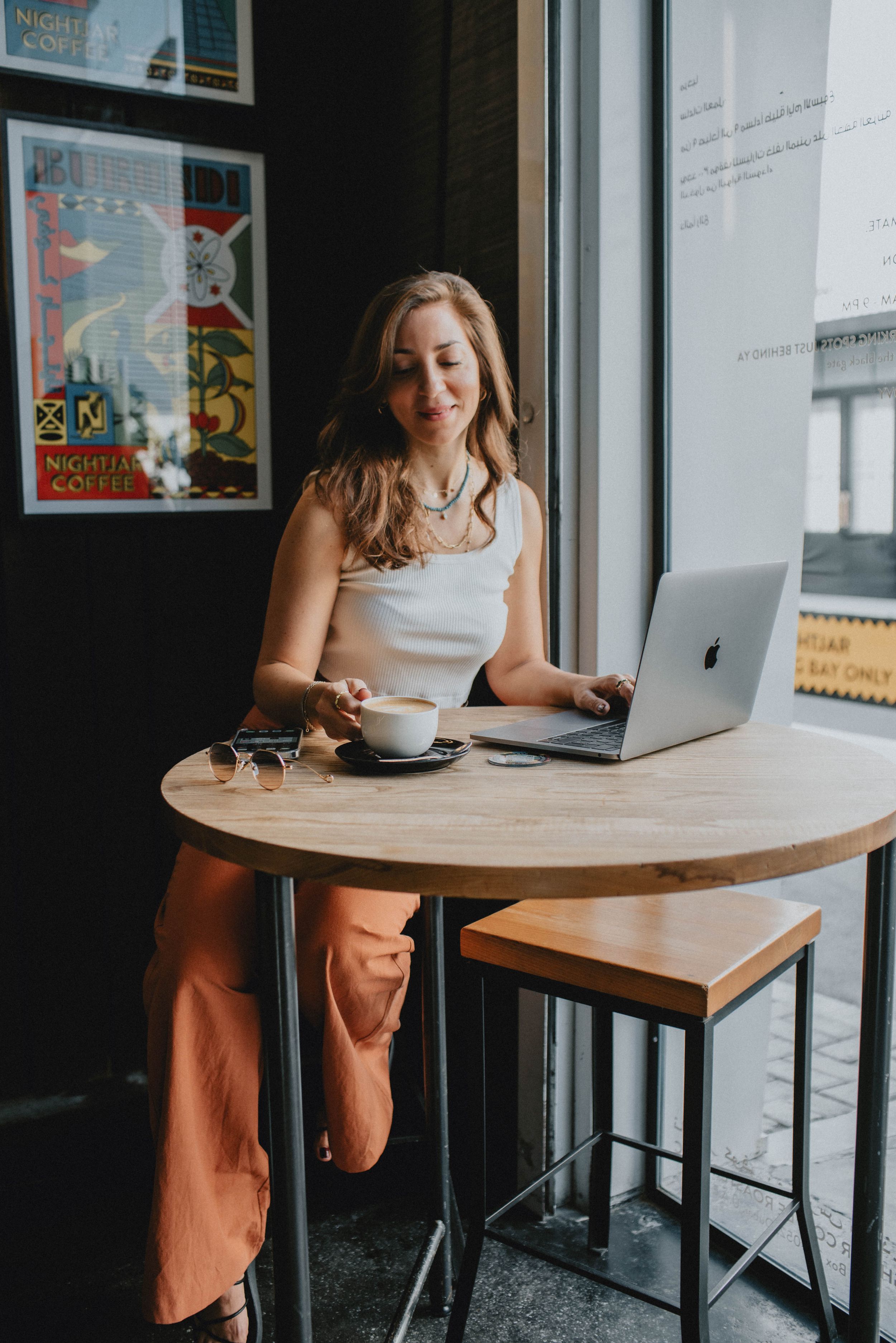 Lifestyle business portrait in Sydney, featuring a professional in a café setting, capturing genuine, approachable, and confident moments.
