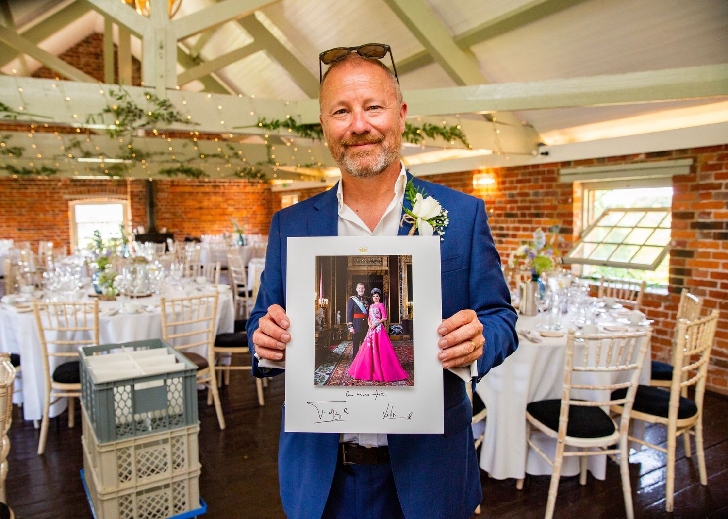 Wedding reception venue with exposed brick walls and table settings.