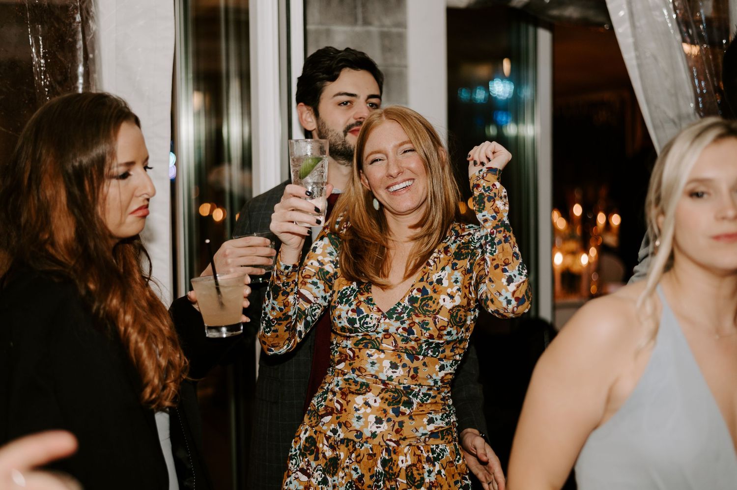 Candid moments of wedding guests laughing and celebrating at an evening reception.