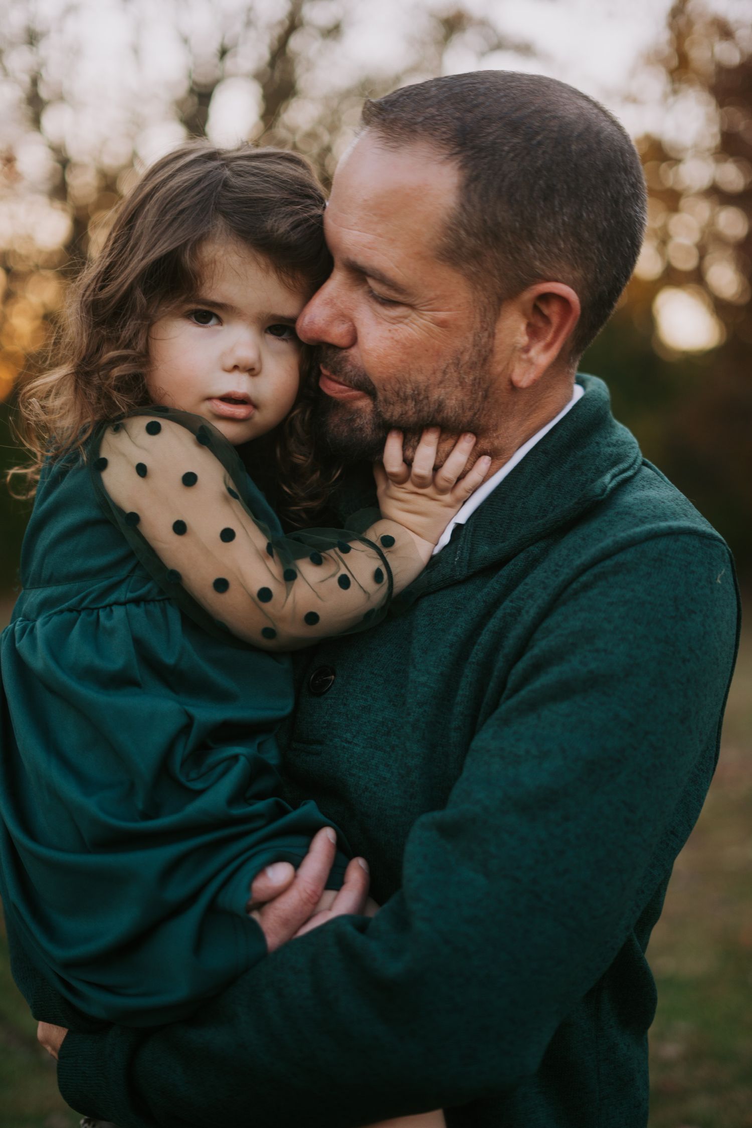 A tender moment captured between a parent and child in warm autumn lighting.